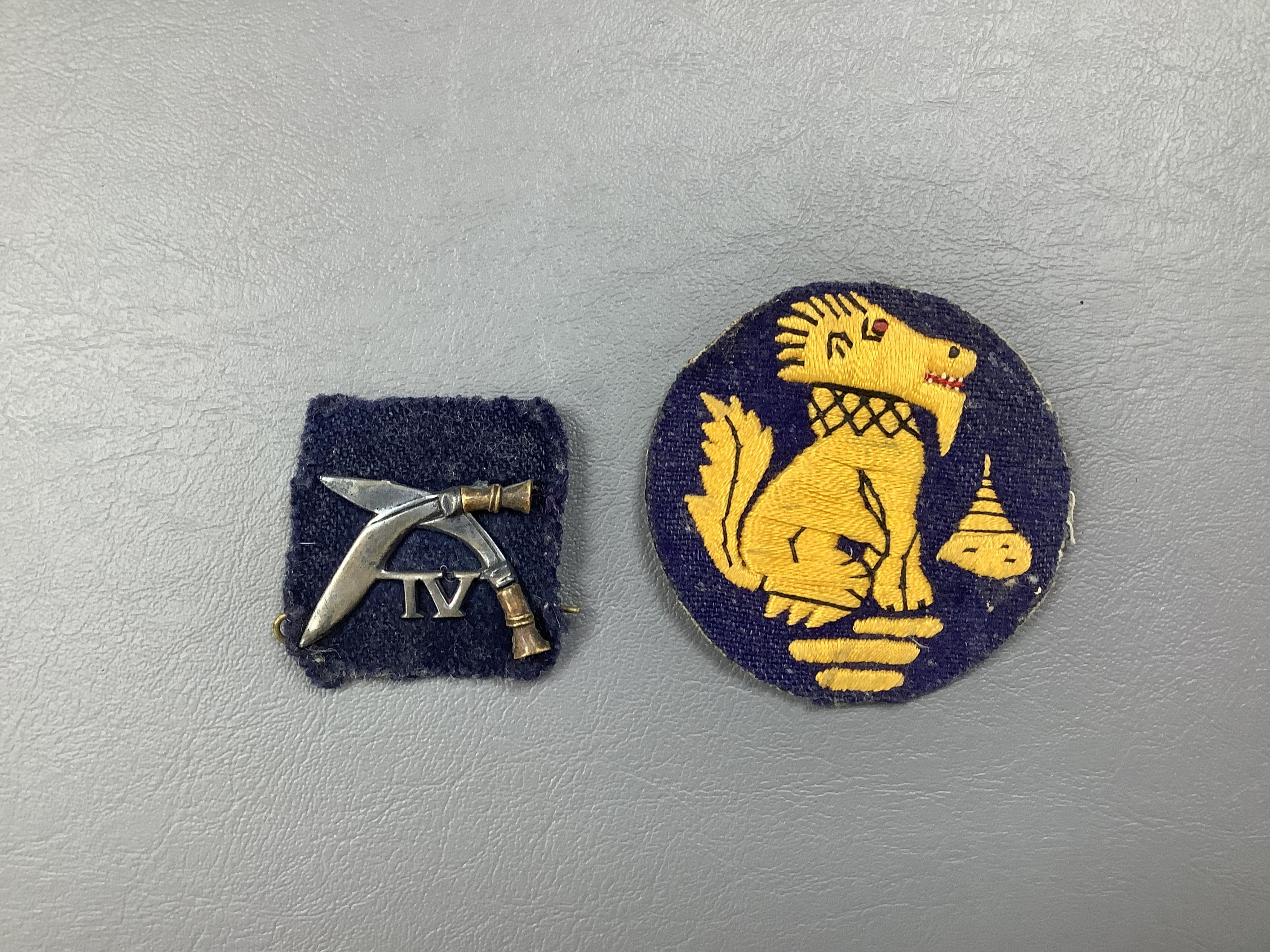 A WWII medal trio comprising a Burma Star, The Defence Medal and the 1939-1945 Medal, contained within their original card issue box, together with a Gurkha cap badge and a few other items. Condition - fair to good.